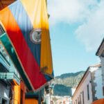 Weathered Ecuadorian flag on a building's balcony