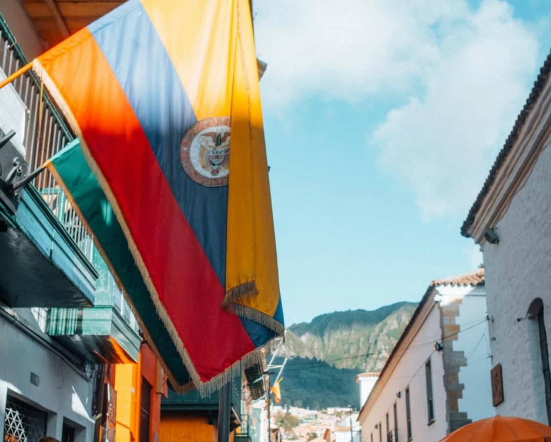 Weathered Ecuadorian flag on a building's balcony