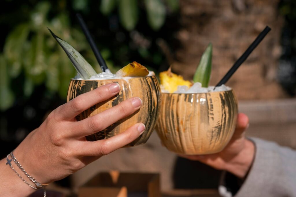 Side view of couple holding pina colada