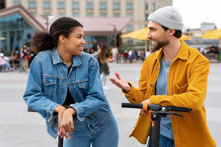 A guy and a girl talking to each other on the street