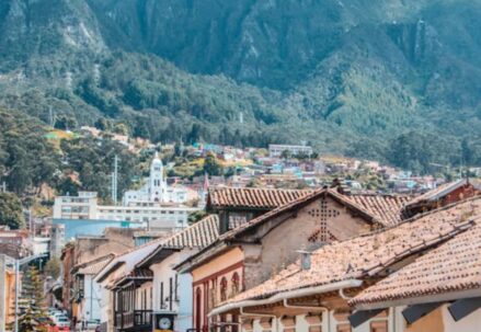 A colonial town with mountains in the background