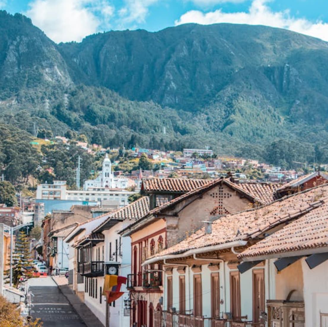 A colonial town with mountains in the background